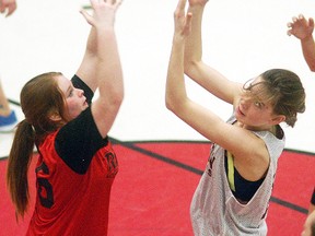 Riverview Central's Mya Baker, left, and Wallaceburg District Secondary School 7-8's Megan McCarter battle for a rebound during a league game at WDSS on Feb. 11. WDSS won by a 62-19 score.