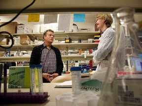 Dr. Andrew Mason (l) chats with Filip Wysokinski at the Faculty of Medicine & Denistry in Edmonton, Alberta on Thursday Feb.19, 2015. Dr Mason spoke to the media pm exploring a viral connection to primary biliary cirrhosis.  Perry Mah/Edmonton Sun