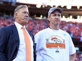 Denver Broncos executive vice president of football operations John Elway and quarterback Peyton Manning (18) after the 2013 AFC championship playoff football game against the New England Patriots at Sports Authority Field at Mile High. (Matthew Emmons-USA TODAY Sports)