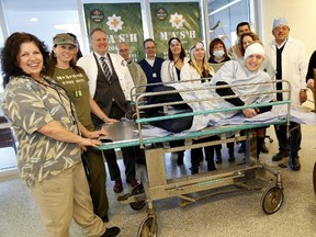 Emily Mountney-Lessard/The Intelligencer
Organizers and volunteers of this year's Belleville General Hospital Foundation gala unveil this year's theme ­ M*A*S*H for the Sept. 19 fundraising event.