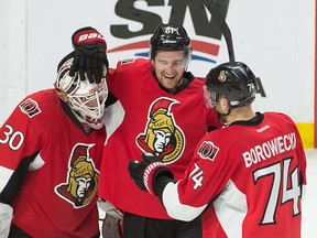 Ottawa Senators goalie Andrew Hammond, right wing Mark Stone (61) and defenceman Mark Borowiecki (74) celebrate their win against the Montreal Canadiens at the Canadian Tire Centre wednesday night. (Marc DesRosiers-USA TODAY Sports)