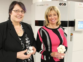 Lambton College's Bluewater Technology Access Centre (BTAC) held an open house at its Additive Manufacturing Laboratory at the Western Sarnia-Lambton Research Park Thursday. The laboratory uses 3D printing to develop prototypes for industries while teaching students about the technology. Here BTAC director Maike Luiken, left, poses with college president Judith Morris in front of a new $250,000 printer. TYLER KULA/ THE OBSERVER/ QMI AGENCY