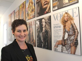Audra Anderson, the founder and president of Mode Elle, a modelling and talent agency that is opening up a new office in Kingston, stands next to magazine covers featuring Liisa Winkler, one of the models she represents. (Michael Lea/The Whig-Standard)