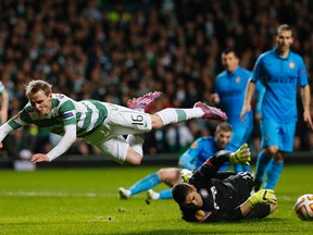 Celtic's Gary Mackay Steven flies over with Inter Milan goalkeeper Juan Pablo Carrizo during Europa League play Thursday at Celtic Park in Glasgow. (Reuters/Russell Cheyne)