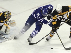 Kingston Frontenacs defenceman Roland McKeown battles for the puck with Mississauga Steelheads’ Nathan Bastian in front of goaltender Jeremy Helvig during Ontario Hockey League action at the Rogers K-Rock Centre on Oct. 10. The Steelheads host the Frontenacs Friday night. (JULIA MCKAY/The Whig-Standard)