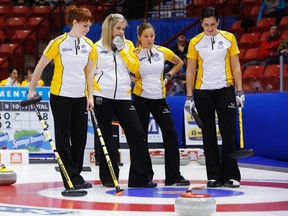 Manitoba lead Dawn McEwen (from left), skip Jennifer Jones, third Kaitlyn Lawes and second Jill Officer discuss their next shot during their game against Nova Scotia at the Scotties Tournament of Hearts in Moose Jaw, Saskatchewan, February 18, 2015. (REUTERS/Todd Korol)