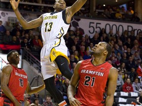 Brent Jennings of the London Lightning lays the ball up to the basket over Marques Oliver of the Brampton A?s during their National Basketball League of Canada game at Budweiser Gardens on Thursday. Brampton won 110-102. (CRAIG GLOVER/The London Free Press)