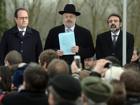 French President Francois Hollande, left, Rene Gutman, Great Rabbi of Bas-Rhin region and French Jewish central consistory president Joel Mergui attend a ceremony Feb. 17 at the Jewish cemetery in Sarre-Union, eastern France, following the desecration of about 300 tombs. Five teenagers have been taken into custody suspected of vandalizing hundreds of Jewish graves, an act that prompted fresh pleas for Jews not to turn their back on France. Columnist Gwynne Dyer says Israeli Prime Minister Benjamin Netanyahu is a crude electioneer in his call for Jews to immigrate to Israel. (PATRICK HERTZOG / Agence France Presse)