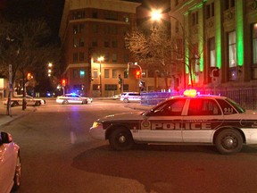 Police stand watch at the scene outside Opera Ultralounge, where a 23-year-old man was killed last May. Charges have been laid in the killing. (Shaun McLeod/Winnipeg Sun file photo)