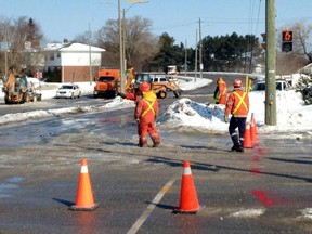 Crews arrive at the intersection of Princess Street and Sir John A. Macdonald Boulevard to repair a broken water pipe. Elliot Ferguson/The Whig-Standard