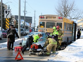 Two people were sent to hospital after a small car collided with a school bus Friday just before noon at the intersection of Concession Street and Macdonnell Street in Kingston, Ont. on Friday February 20, 2015. Shortly after, the tow-truck sent to remove the car was also rear ended.  Steph Crosier/Kingston Whig-Standard/QMI Agency