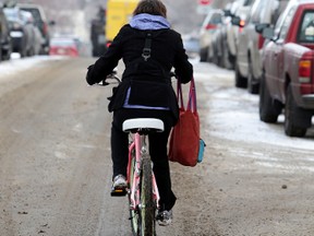 Cathy Griwkowsky try to commute on a bike in downtown Edmonton, Alberta on Wednesday Feb.18, 2015. Perry Mah/Edmonton Sun