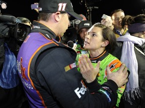 Danica Patrick, driver of the #10 GoDaddy Chevrolet, and Denny Hamlin, driver of the #11 FedEx Express Toyota, talk about their in-race incident on pit road after the the NASCAR Sprint Cup Series Budweiser Duel 2 at Daytona International Speedway on February 19, 2015. (Jared C. Tilton/Getty Images/AFP)