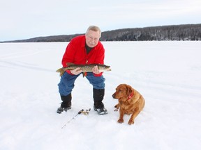 Neil and his fox red Lab Penny with a Battle Lake pike. (Neil Waugh photo)