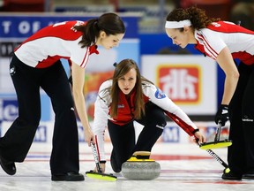 Team Canada skip Rachel Homan delivers a shot with lead Lisa Weagle (left) and second Joanne Courtney against Northern Ontario during the Scotties Tournament of Hearts in Moose Jaw, Saskatchewan, February 20, 2015. (REUTERS/Todd Korol)