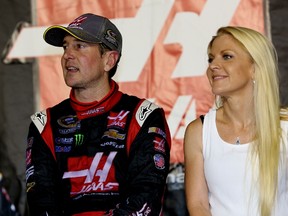 Kurt Busch stands on pit road with Patricia Driscoll after qualifying for the Chase for the Sprint Cup during the NASCAR Sprint Cup Series Federated Auto Parts 400 at Richmond International Raceway on September 6, 2014. (Jerry Markland/Getty Images/AFP)