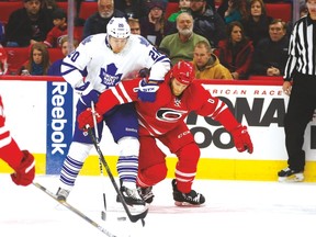 Leafs forward David Booth battles for the puck against Carolina’s Tim Gleason on Friday night. (USA TODAY SPORTS)