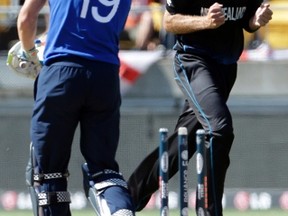 New Zealand’s Tim Southee (right) celebrates bowling England’s Chris Woakes (left) for one run during their Cricket World Cup match at Wellington Stadium in Wellington on Thursday. The Kiwis sent England to an embarrassing eight-wicket defeat. (REUTERS/PHOTO)