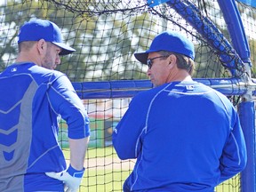 Blue Jays catcher Josh Thole gets a few words of advice from new hitting coach Brook Jacoby on Friday in Dunedin. (EDDIE MICHELS, photo)