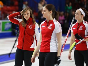 Team Canada skip Rachel Homan, lead Lisa Weagle and second Joanne Courtney react after their loss to Saskatchewan during the Page playoff game in the Scotties Tournament of Hearts in Moose Jaw, Saskatchewan, February 21, 2015. (REUTERS/Todd Korol)