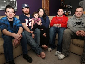 Kayla Bodman (centre) sits with husband Tyler  and daughter Wednesday, along with her brothers Carson, Breydon and Brett (from left) in their Riverbend home on Thu., Feb. 19, 2015. The Bodmans are having a belated wedding social on Feb. 27 to assist with some of the issues they've encountered since Kayla's mom died in November.