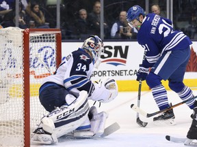 Toronto Maple Leafs left wing James van Riemsdyk (21) shoots the puck against Winnipeg Jets goalie Michael Hutchinson (34) at Air Canada Centre. The Maple Leafs won 4-3 in overtime. (Tom Szczerbowski-USA TODAY Sports)