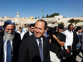 Jerusalem Mayor Nir Barkat (C) walks after praying at the Western Wall in Jerusalem's Old City, in this October 23, 2013 file photo. Barkat and his security guard wrestled a Palestinian attacker to the ground near city hall on February 22, 2015 after an ultra-Orthodox Jew was stabbed at a busy city intersection. REUTERS/Baz Ratner/Files