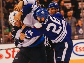 Toronto Maple Leaf  Daniel Winnik fights with Winnipeg Jets Ben Chiarot at the ACC. in Toronto, Ont. on Saturday February 21, 2015. The Jets are back in action at home to the Dallas Stars on Tuesday. (Dave Thomas/Toronto Sun/QMI Agency)