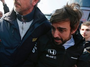 McLaren Formula One driver Fernando Alonso crashed during the final day of tests at the Catalunya's racetrack in Montmelo, near Barcelona, on Sunday, Feb. 22, 2015. (Albert Gea/Reuters)