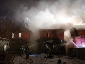 Firefighters battle a house fire along 94 Street near 113 Avenue on Saturday. David Bloom/Edmonton Sun/QMI Agency