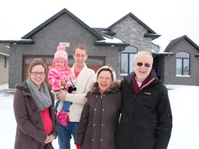 Judy and John Scholz are the grand-prize winners of this year's Dream Home Lottery in Sarnia. They're pictured outside their Kamal Drive prize with daughter Beth Regimbald, her partner Mike, and the Regimbalds' two-year-old daughter Violet. TYLER KULA/ THE OBSERVER/ QMI AGENCY