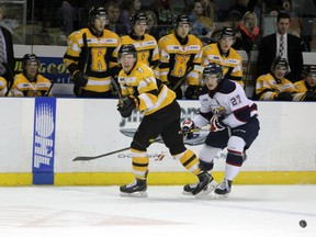 Kingston Frontenacs defenceman Jarkko Parikka clears the puck while being pursued by Saginaw Spirit's Mitchell Stephens during Ontario Hockey League action at the Rogers K-Rock Centre on Sunday. The Frontenacs fell to the Spirit 3-1.  (Steph Crosier/The Whig-Standard)