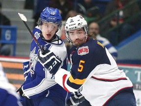 Barrie Colts' Chadd Bauman and Sudbury Wolves' Michael Pezzetta fight for position during OHL action from the Sudbury Community Arena on Sunday February 22/2015.