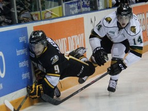 Sarnia Sting forward Troy Lajeunesse falls trying to get past London Knights defenceman Brandon Crawley in this filed photo. Lajeunesse is now a members of the Sudbury Wolves. (TERRY BRIDGE/THE OBSERVER)
