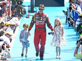 eff Gordon takes son Leo and daughter Ella with him during the pre-race introductions on Sunday at the Daytona 500. (AFP)