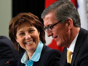 British Columbia Premier Christy Clark (L) talks with Newfoundland and Labrador Premier Paul Davis during a news conference following a meeting of provincial and territorial premiers in Ottawa January 30, 2015. REUTERS/Chris Wattie