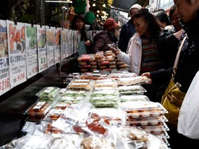 Shoppers look at packs of food at the Ameyoko Shopping street in Tokyo February 23, 2015. (REUTERS/Yuya)