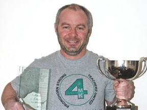 Vulcan resident Sean Carey was recently recognized with a coach of the year award in the Alberta Major Soccer League after his team, the men's Lethbridge Football Club, won the league championship last season. Here, Carey is pictured at his Vulcan home with his coach of the year award, left, and the league trophy.