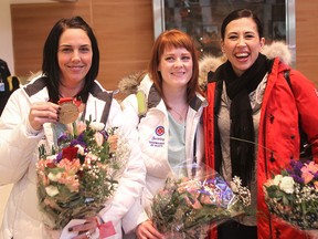 Members of the Jennifer Jones rink (l-r) Jennifer Clark-Rouire, Dawn McEwen and Jill Officer arrive at James Richardson Airport in Winnipeg, Man. Monday February 23, 2015 following their win at the 2015 Scotties Tournament of Hearts.
Brian Donogh/Winnipeg Sun/QMI Agency