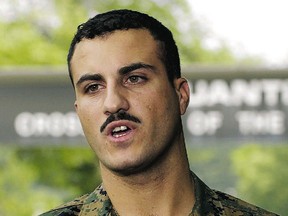 U.S. Marine Corps Corporal Wassef Ali Hassoun reads a prepared statement outside the gate at Quantico Marine Corps Base in Northern Virginia, 35 miles south of Washington, July 19, 2004. (Files)