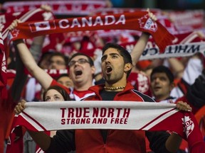 Canadian fans sing the national anthem before the CONCACAF Women's Olympic qualifying soccer match. 
REUTERS file photo/Andy Clark