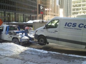 A van with Alberta plates is towed on Wellington and York Sts. (Toronto Police Photo)