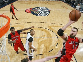 Raptors’ Jonas Valanciunas shoots over the Pelicans’ Omer Asik in New Orleans last night. Valanciunas had a double-double. (afp)