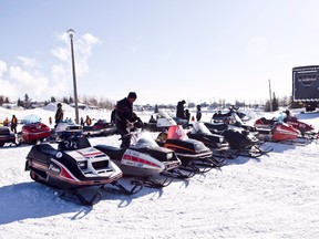 Vintage Snowmobiles sit by Lake Commando during the Vintage Classic Snowmobile drag races on Sunday Feb 8th which took place Lake Commando.