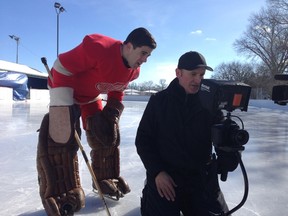 Markian Tarasiuk, left, and director Danny Schur look over footage at Riverview Community Club from a day shooting the documentary on the life of Winnipeg hockey legend Terry Sawchuk.