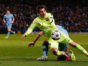Barcelona's Lionel Messi is fouled by Manchester City's Pablo Zabaleta for a penalty during Champions League play at Etihad Stadium in Manchester Tuesday. (Reuters/Jason Cairnduff)