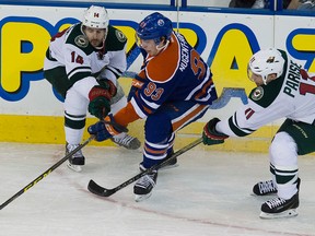 Justin Fontaine, left, tries to strip the puck from Ryan Nugent-Hopkins during Friday's game at Rexall Place. (David Bloom, Edmonton Sun)