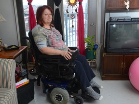 Kelly Hay sits in a wheelchair loaned to her after her scooter was stolen on Feb. 7. (MORRIS LAMONT, The London Free Press)