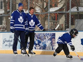 Toronto Maple Leafs player Peter Holland and Toronto Mayor John Tory (middle) chat along the boards at Trinity-Bellwoods arena on Tuesday. (JACK BOLAND, Toronto Sun)