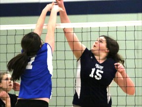 College Avenue Knights Dawn McDowell, right, tips the ball over the attempted block by a Parkside Collegiate Institute player in the TVRA Southeast Division junior girls' volleyball final in St. Thomas, Ont. on Tuesday February 24, 2015. CASS won 3-1 to win the Southeast Division title and will play at WOSSAA Friday at St. Mary's. Greg Colgan/Woodstock Sentinel-Review/QMI Agency